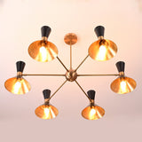 Bottom view of 12-light brass and black mid-century cone chandelier with glowing gold interiors and warm light output.