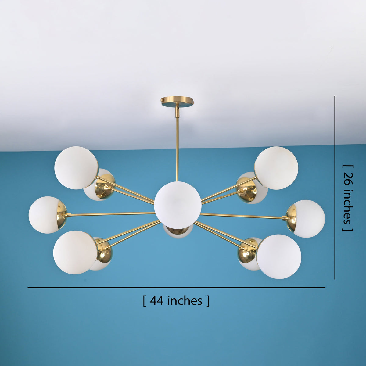 12 light brass globe chandelier showing 44 inch width and 26 inch height with modern mid century design