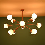 Handmade 12 opal glass brass chandelier producing soft ambient glow with mid century modern aesthetic