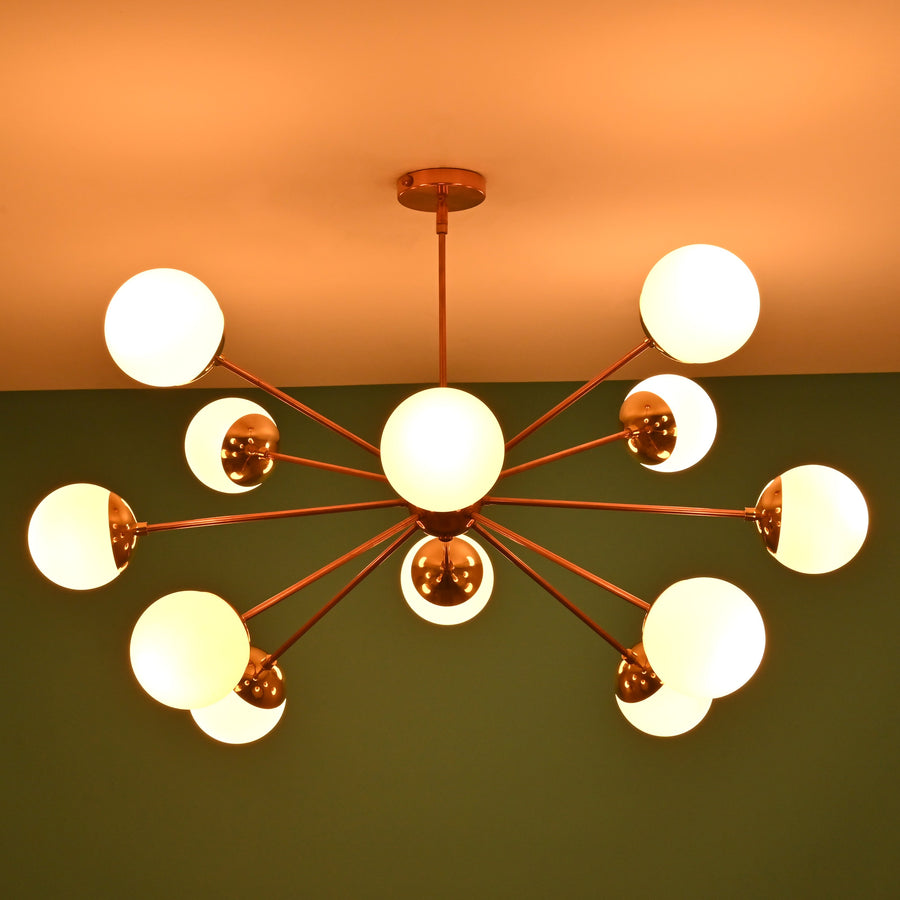 12 opal glass sputnik chandelier in solid brass with mid century modern radial design, warm ambient ceiling lighting