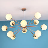 Illuminated 12 opal glass sputnik chandelier in brushed brass finish creating warm ambient light