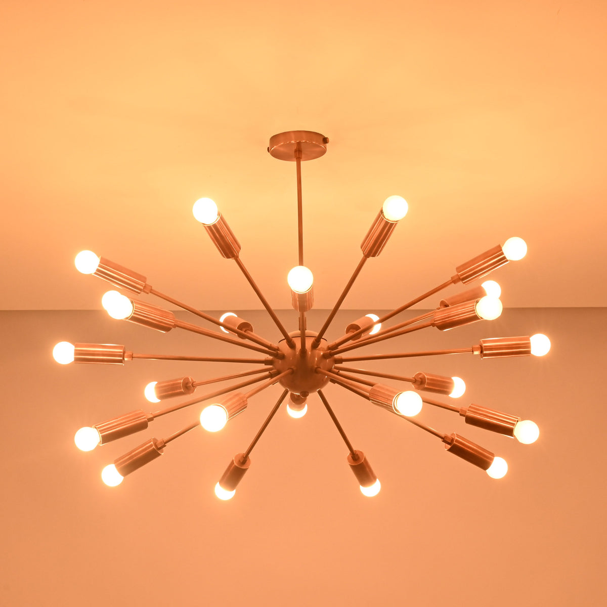 Wide view of 24 light brass sputnik chandelier casting warm ambient light across the ceiling.