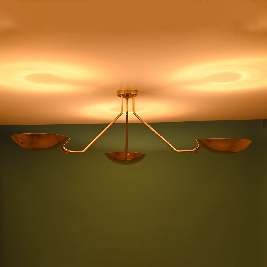 Minimalist 3 light brass bowl chandelier with disc shaped shades mounted close to ceiling