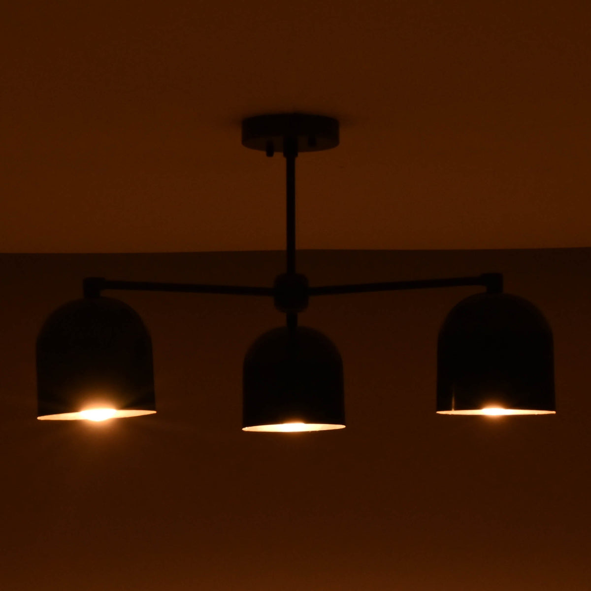 Soft glowing 3 light brass chandelier creating a cozy and inviting atmosphere.