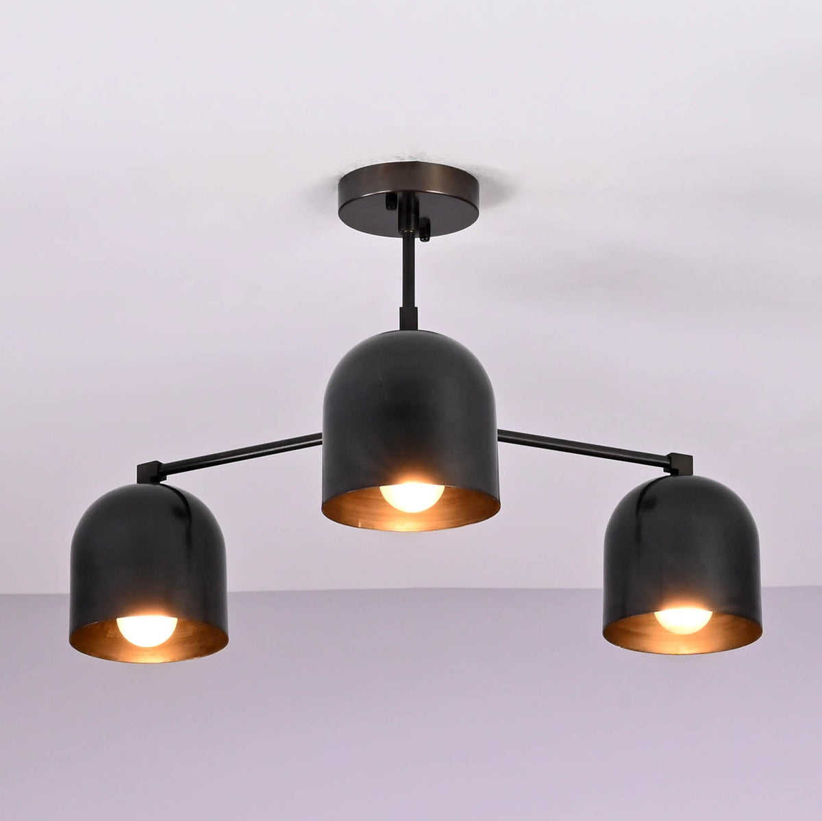 Symmetrical design of a handcrafted 3 light brass ceiling chandelier with minimalist arms.