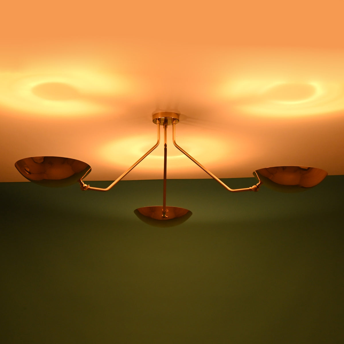 Unlit 3 light brass bowl flushmount ceiling fixture showing solid brass construction and minimalist form