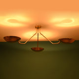 Unlit 3 light brass bowl flushmount ceiling fixture showing solid brass construction and minimalist form