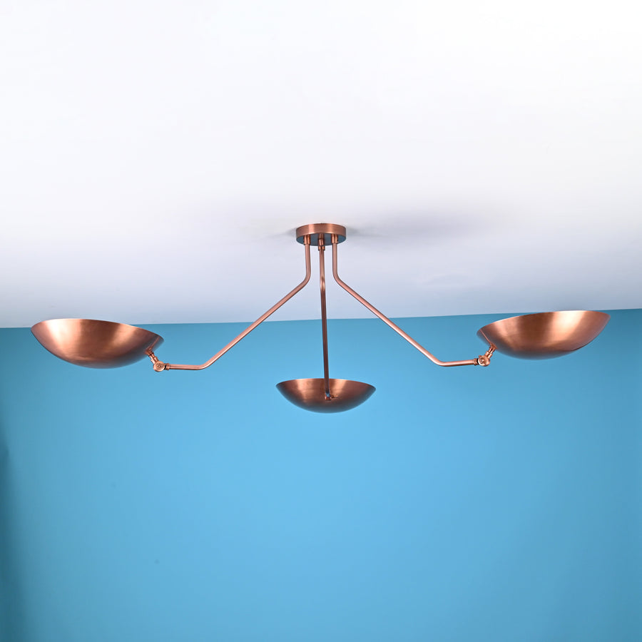 Modern 3 light brass flush mount ceiling light with bowl shaped shades and clean minimalist industrial arms