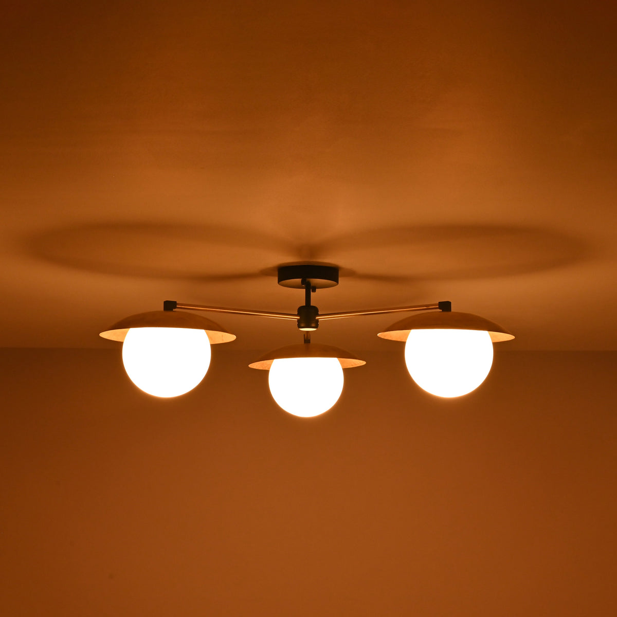 Installed view of 3 light brass disc flush mount ceiling light designed for low ceiling interiors.