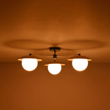 Installed view of 3 light brass disc flush mount ceiling light designed for low ceiling interiors.