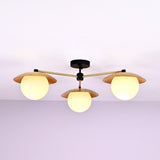 Front view of 3 light brass disc flush mount ceiling light with opal glass globes and modern industrial design.