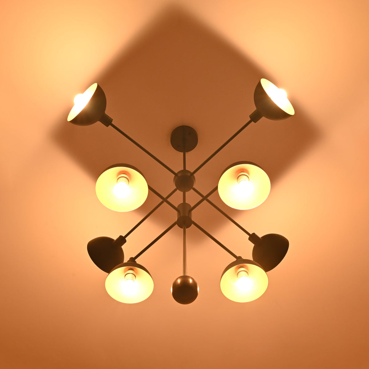 8-Light Brass Chandelier Top View – Geometric Black and Gold Pendant with Glowing Shades