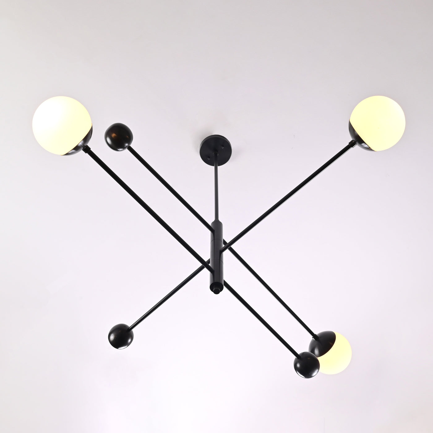 Minimalist matte black 3-light chandelier with balanced linear arms – upward view