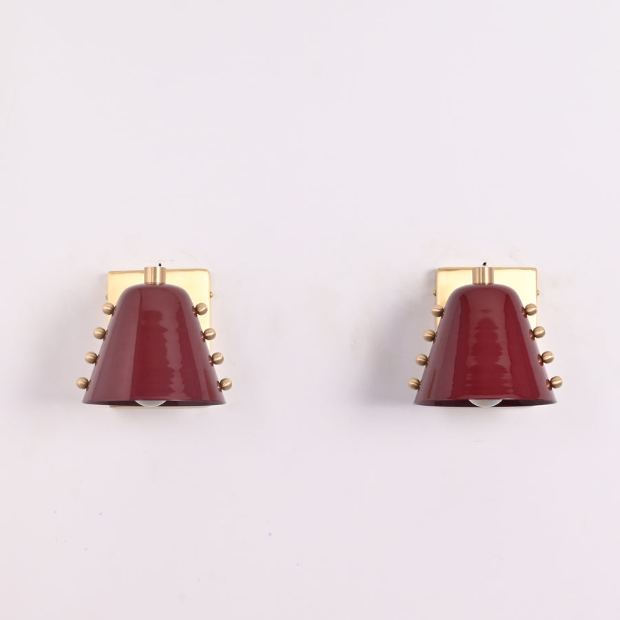 Modern brass cone wall sconce with burgundy metal shade and brushed brass backplate