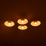 Four circular lights emitting a warm glow against a dark background