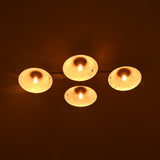 Four lit candles on a dark background