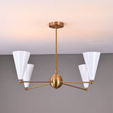 Close-up of brass chandelier with white enamel cone shades, mid-century modern ceiling light.
