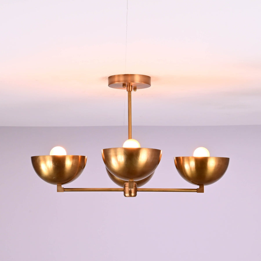 Front view of a handcrafted 4 bowl brass chandelier in brushed brass finish, featuring a minimalist flush mount ceiling design with warm ambient lighting.