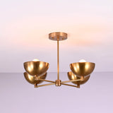 Side profile of a brushed brass 4 bowl chandelier displaying its clean horizontal arm structure and softly curved brass shades.