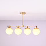 Front view of 4 linear brass chandelier with opal glass globe shades, showcasing minimalist industrial design and warm ambient lighting.