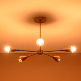 Bottom view of glowing 5-light brass cone chandelier, showing perfect arm balance and polished brass finish craftsmanship.
