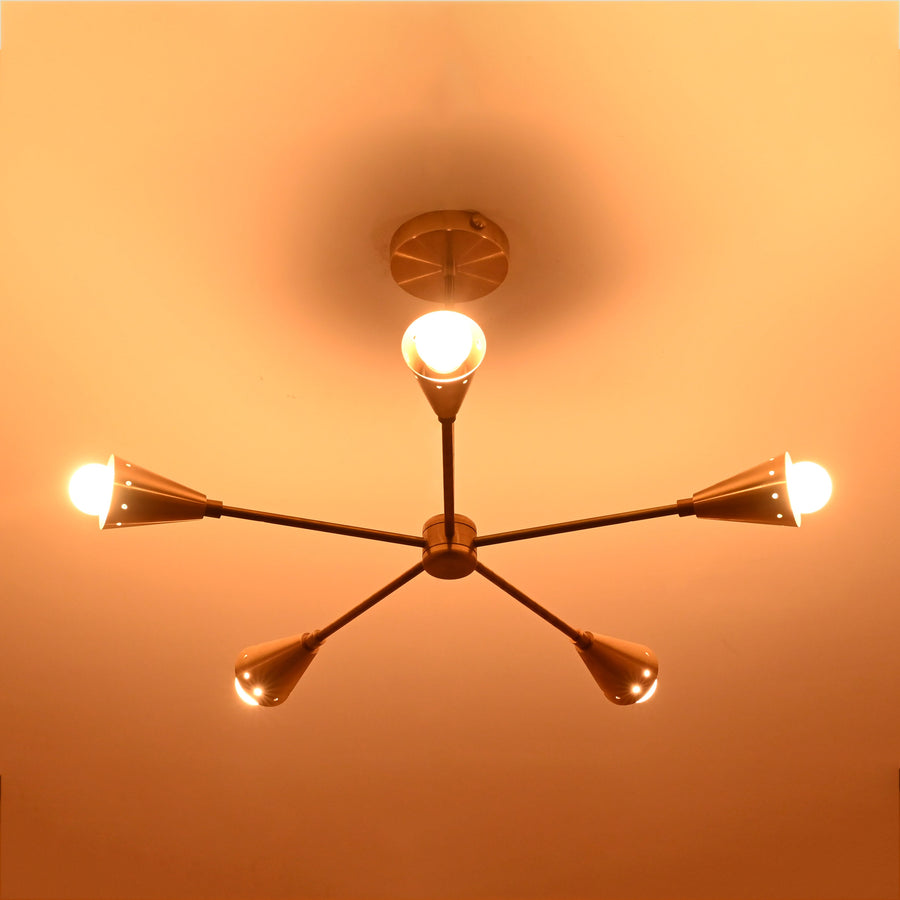 Handmade 5-light brass cone arm ceiling light in brushed brass finish, showcasing symmetrical mid-century modern design with conical shades by Brass Leaf Studio.