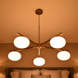 5-light chandelier with oval opal glass balls, brass arms, and clean modern ceiling-mounted design