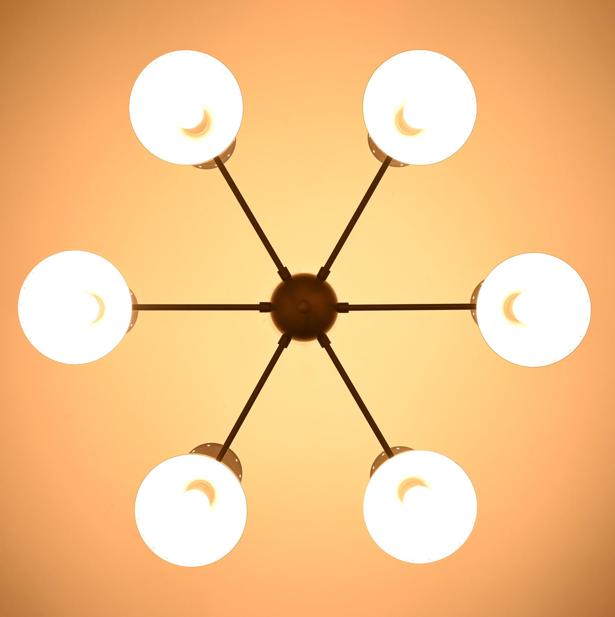 Underside view of illuminated 6 Brass Diabolo chandelier highlighting warm indirect lighting and solid brass construction