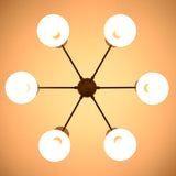 Underside view of illuminated 6 Brass Diabolo chandelier highlighting warm indirect lighting and solid brass construction