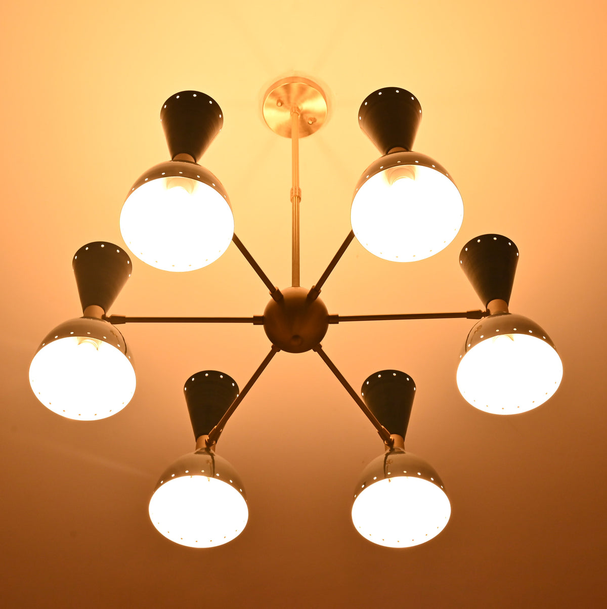 6 Brass Diabolo 12-light chandelier creating warm modern ambience in contemporary interior setting