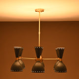 Moody lighting view of 6 Brass Diabolo 12-light chandelier with warm glow and luxury handcrafted brass finish