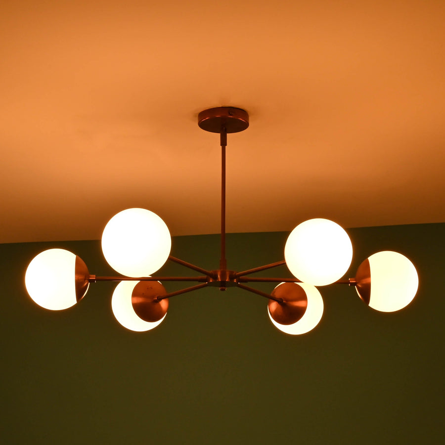 6 light glass globe brass chandelier with mid-century modern industrial design, solid brass arms and opal glass shades by Brass Leaf Studio