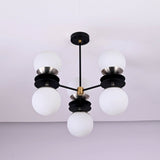 Bottom view of six light brass chandelier featuring opal glass globes and layered disc design