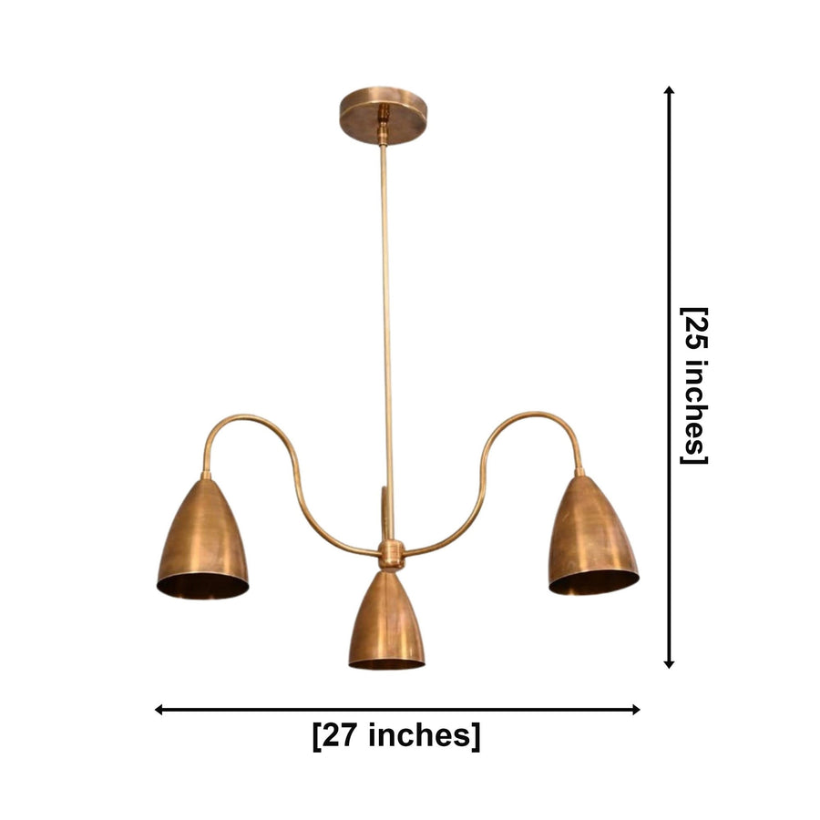 Marbella 3 light aged brass cone arm chandelier illuminated in an elegant warm bedroom interior above the bed.