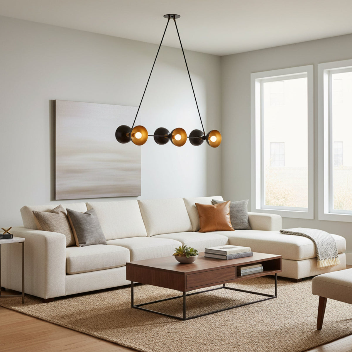 Modern multi-light chandelier with four black spherical shades and four brushed gold conical reflectors, suspended by black cords from a round ceiling canopy on a white background.
