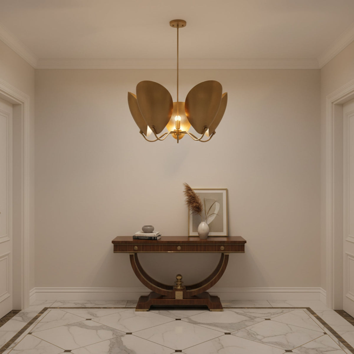 A modern five-light brass chandelier with a central light bulb glowing warmly, suspended by a single rod from a circular ceiling canopy against a solid white background.