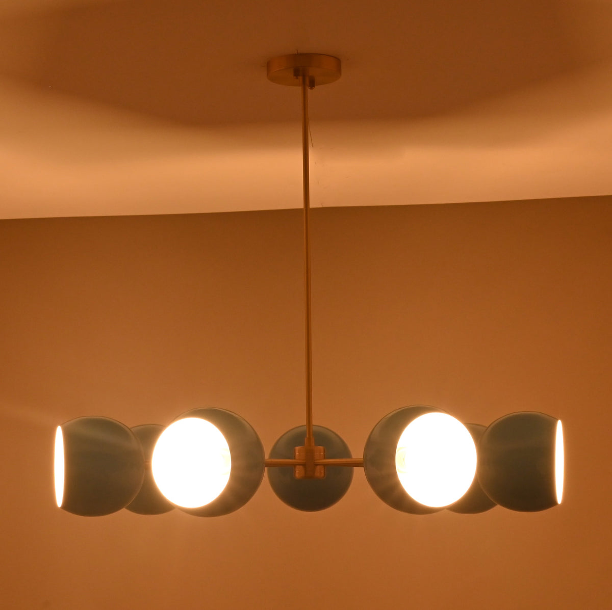 Front installed view of 7 bowl blue glass chandelier handcrafted in solid brass