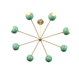 Angled top view of 7 bowl green sputnik chandelier in brushed brass with sculptural modern design