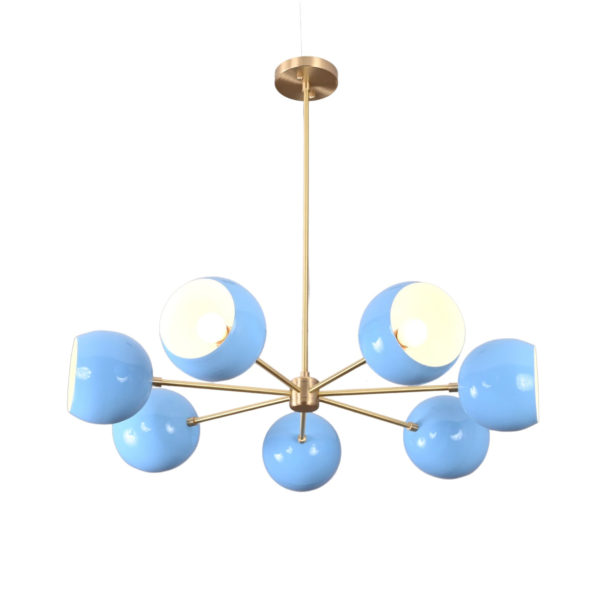 Angled view of modern 7 bowl brass chandelier with blue glass shades in mid century design