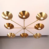 Bottom view of 8-light brass disc chandelier with radiating arms and circular brass shades.
