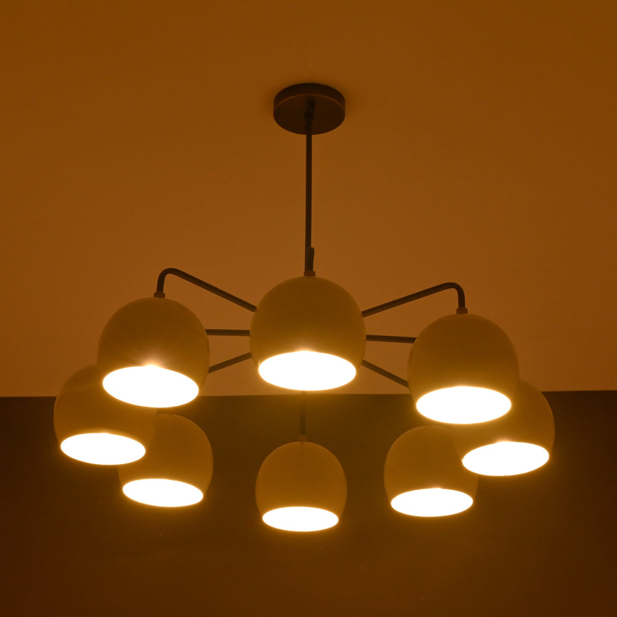 Front view of handcrafted 8-light brass chandelier with ivory bowl shades and bronze finish by Brass Leaf Studio.