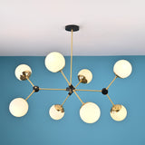 Top-down view of an 8-light brass sputnik chandelier displaying symmetrical arm layout and opal glass globe shades.