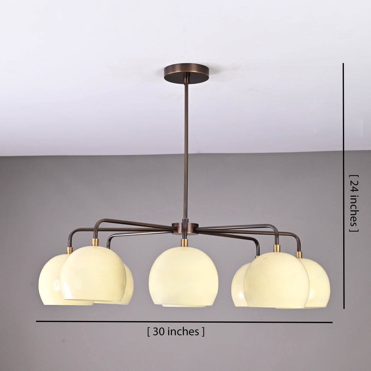 Modern 8-light brass chandelier showing 30-inch width and 24-inch height dimensions with cream bowl-shaped shades.