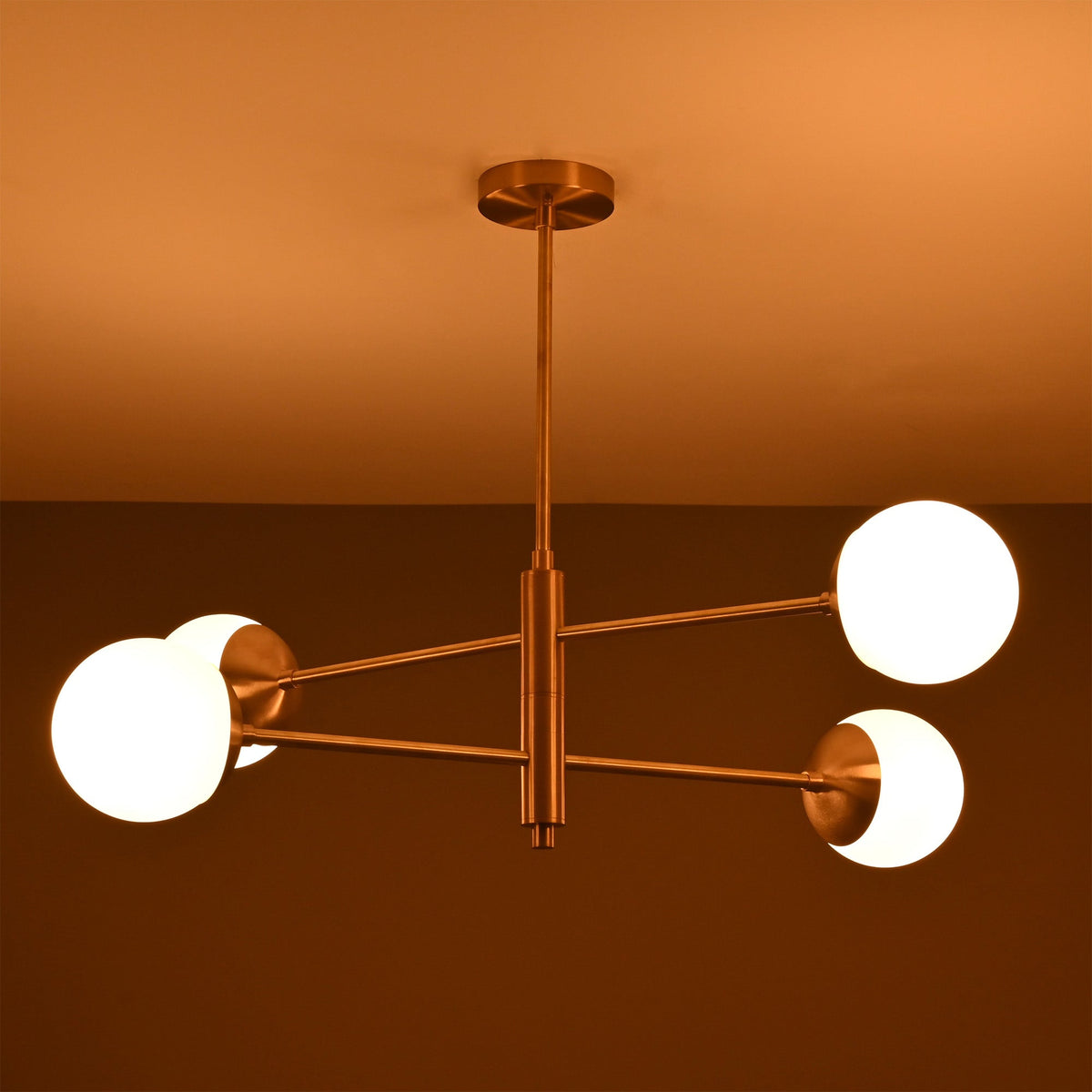 Astra 4 Globe Sputnik Chandelier illuminated on ceiling with warm ambient light and modern balanced form