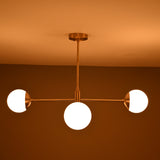 Astra 4 Globe Sputnik Chandelier installed on ceiling with warm glow and three visible round shades
