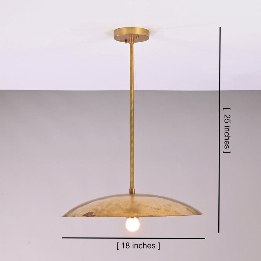 Aurelia Petite Saucer Pendant Light installed above a kitchen island in a warm modern interior.
