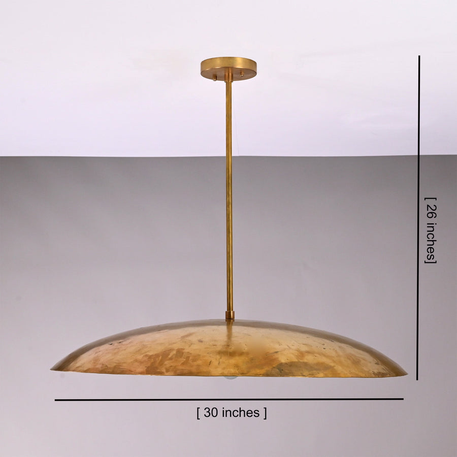 Aurelia Saucer Pendant Light installed above a round dining table in a warm modern interior.
