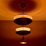 Close view of Aurelia Tiered Disc Chandelier showing layered round shades and warm ambient illumination.