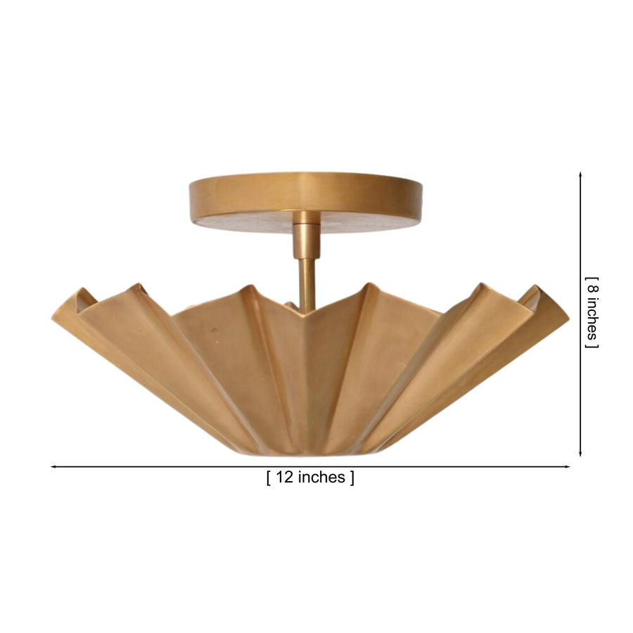 Aurora Fluted Petal flush mount ceiling light installed in a contemporary living room, providing warm ambient illumination with its sculptural brass fluted shade.