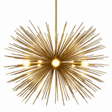 Belgravia 6 light brass tone sunburst Sputnik chandelier illuminated against a white background, highlighting its dramatic starburst design.